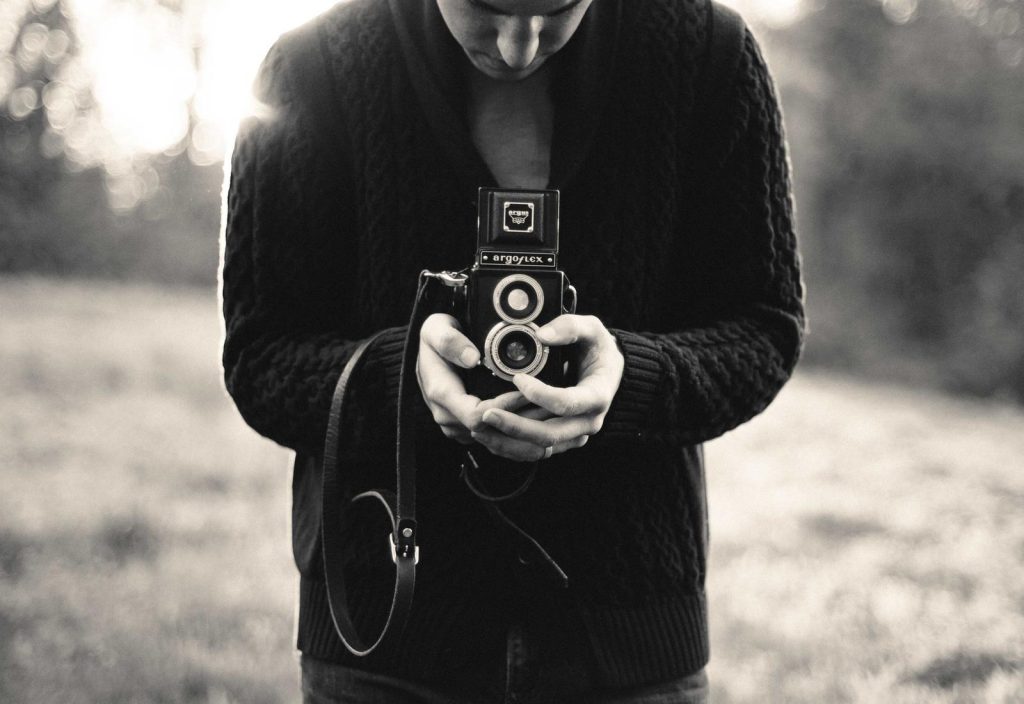 A photographer with a twin-lens camera